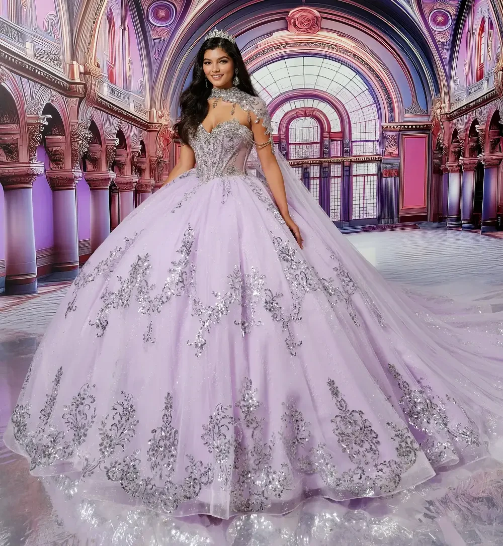 A young woman in a stunning lavender ball gown with intricate silver detailing and gemstones, standing in a grand, decorative setting that resembles a luxurious ballroom.